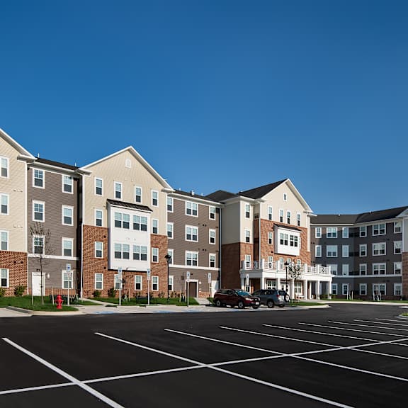 an empty parking lot in front of an apartment building