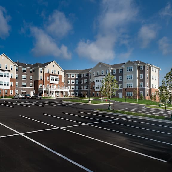 an empty parking lot in front of an apartment building