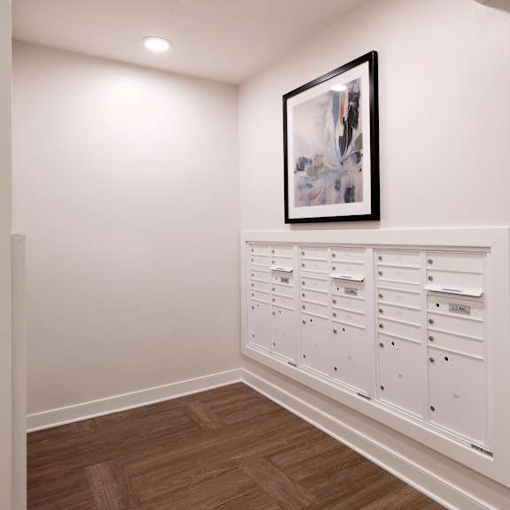 a row of white chests of drawers in a white room
