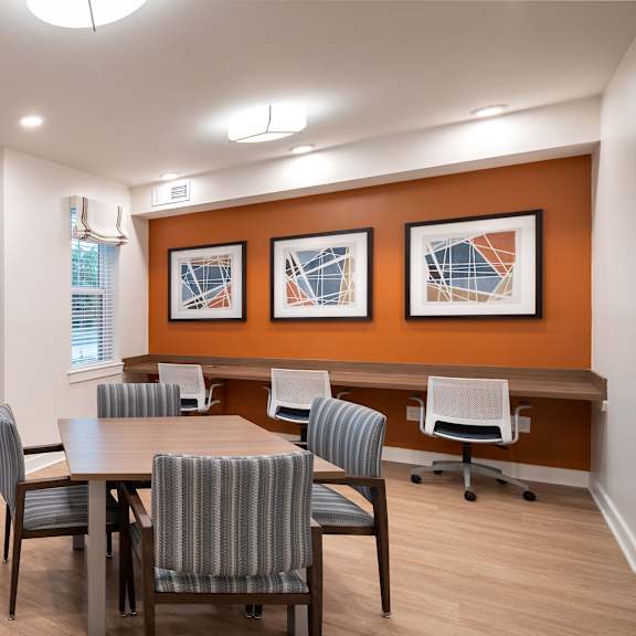 a conference room with a table and chairs and a window