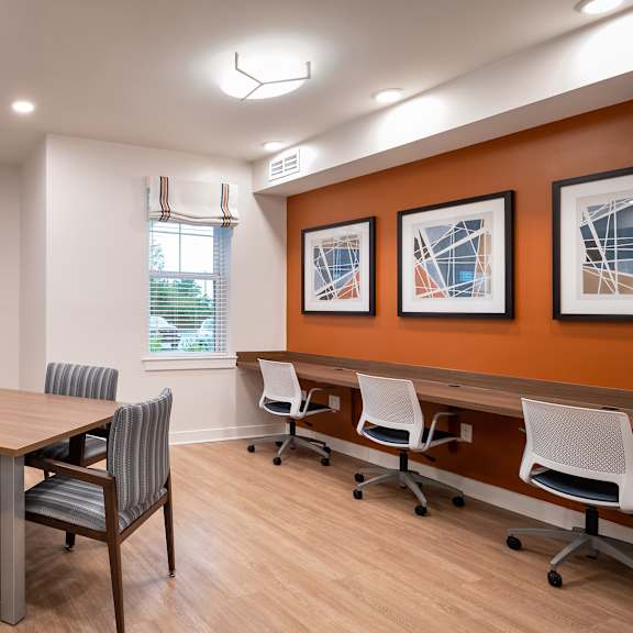 a conference room with a wooden table and chairs