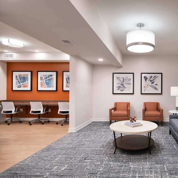a living room with couches and chairs and a table