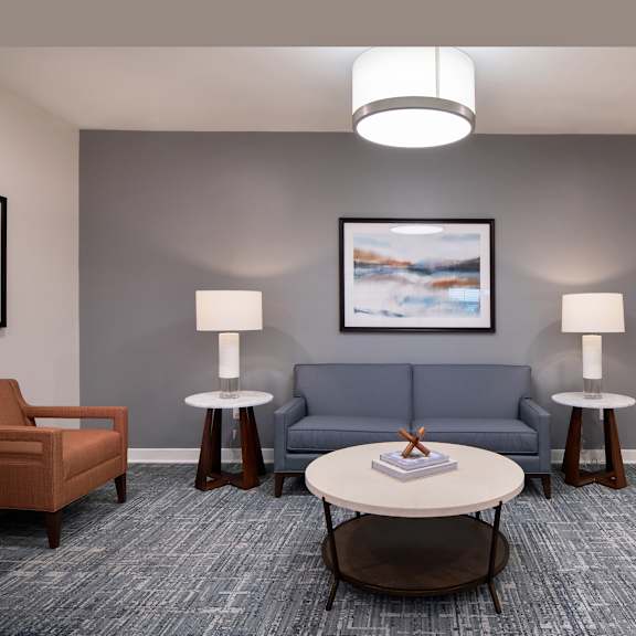 a living room with a blue couch and a coffee table