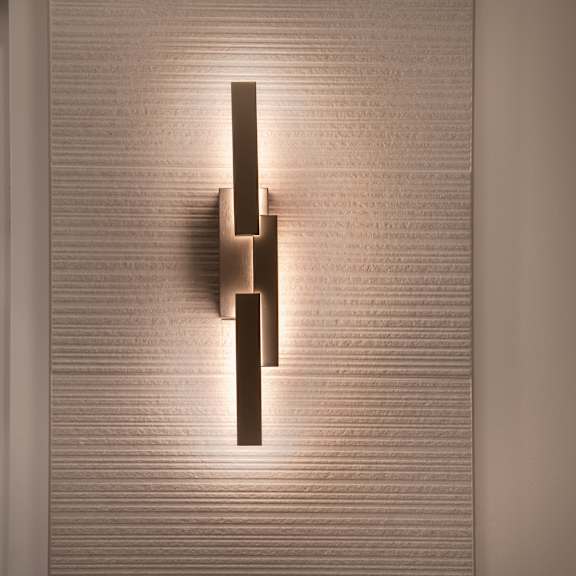 a wall light with a shadow on a wall