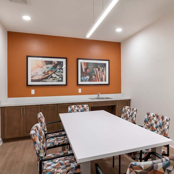 a meeting room with a white table and chairs