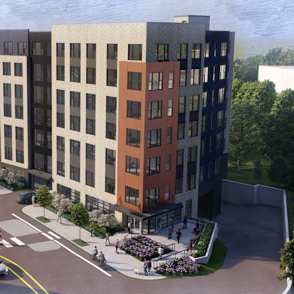 a modern building with a parking lot in front of it.