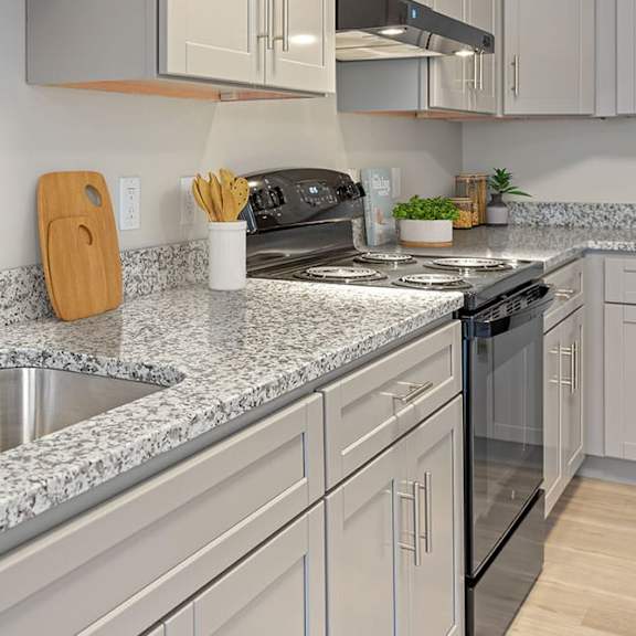 a kitchen with granite countertops and a black oven.
