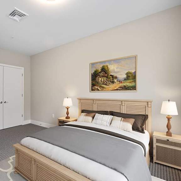 a bedroom with a bed, nightstands, and a painting on the wall.