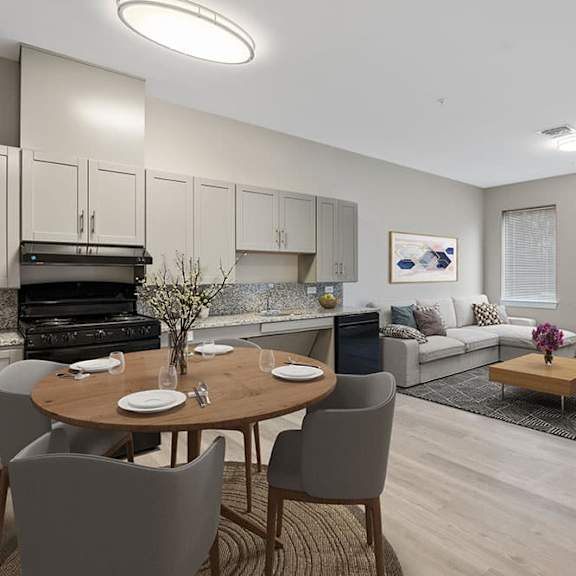 a modern kitchen with a dining table set for two.