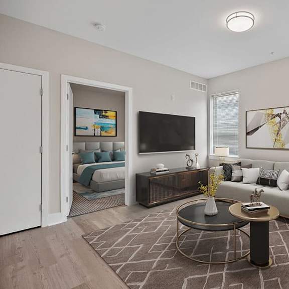 a living room with a grey sofa, a coffee table, and a painting on the wall.