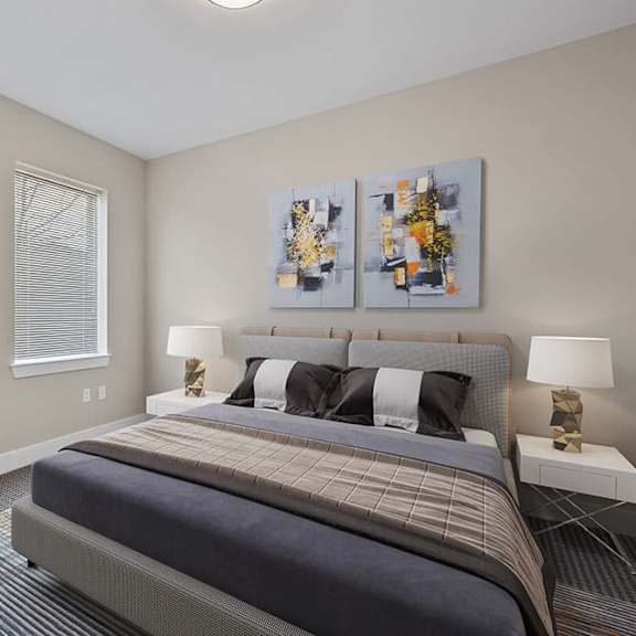 a bedroom with a large bed and two lamps.