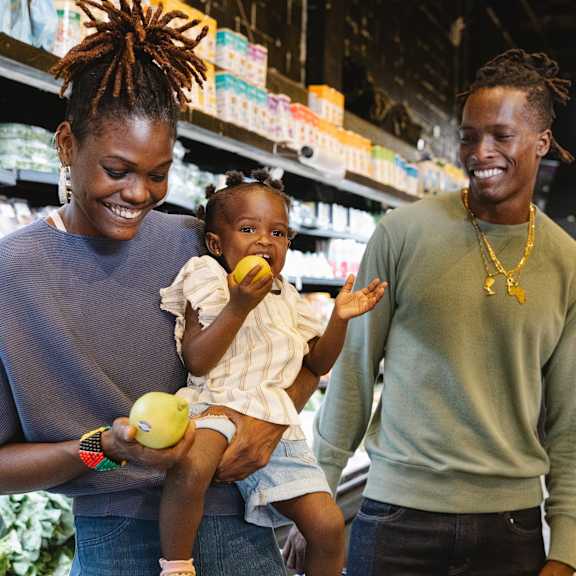 young family smiling while shopping