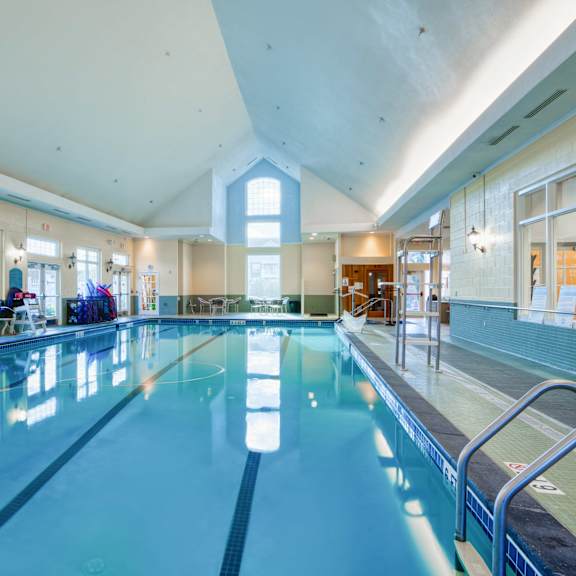 a swimming pool in a building with a large window