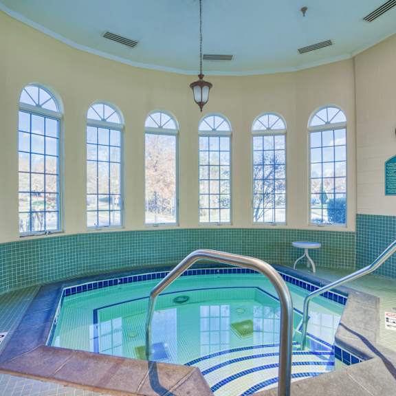 a spa with a pool and a row of windows
