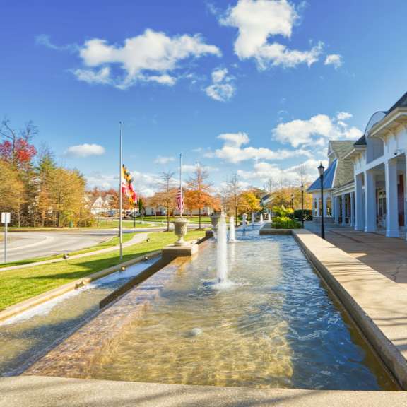 a fountain in front of a building on a sunny day