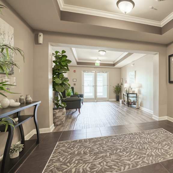 a large hallway with a rug and a door to a lobby