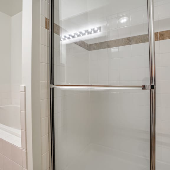 a white bathroom with a shower and a tub