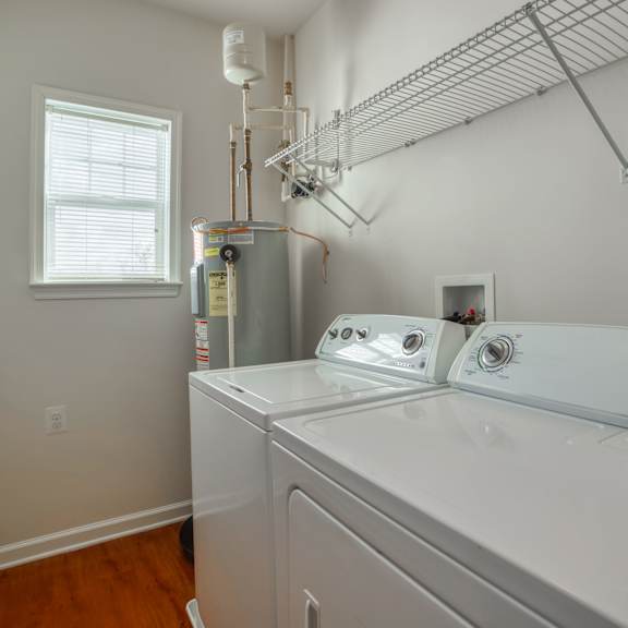 the laundry room has a washer and dryer and a window
