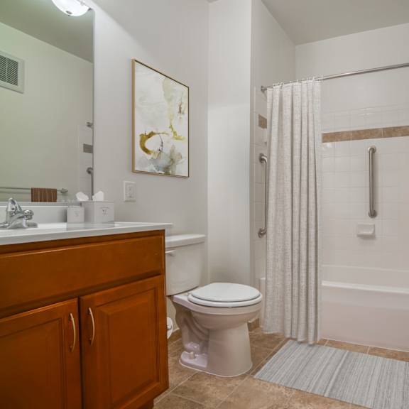 a bathroom with a shower and a toilet and a sink
