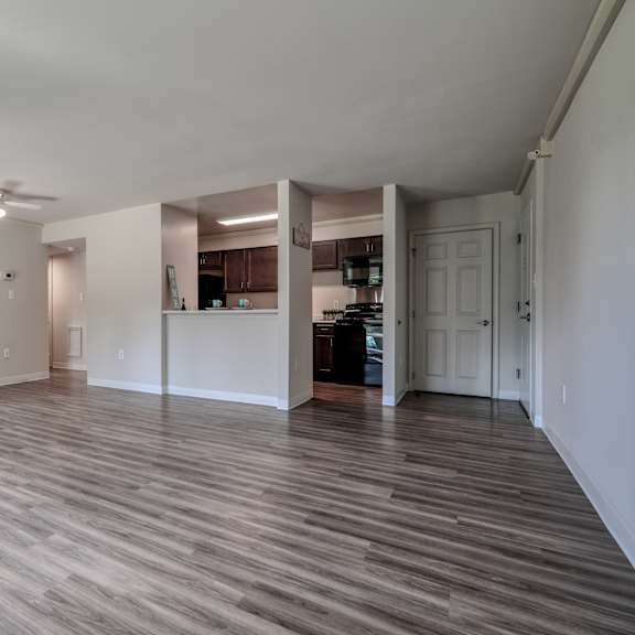 an empty living room and kitchen in a new home