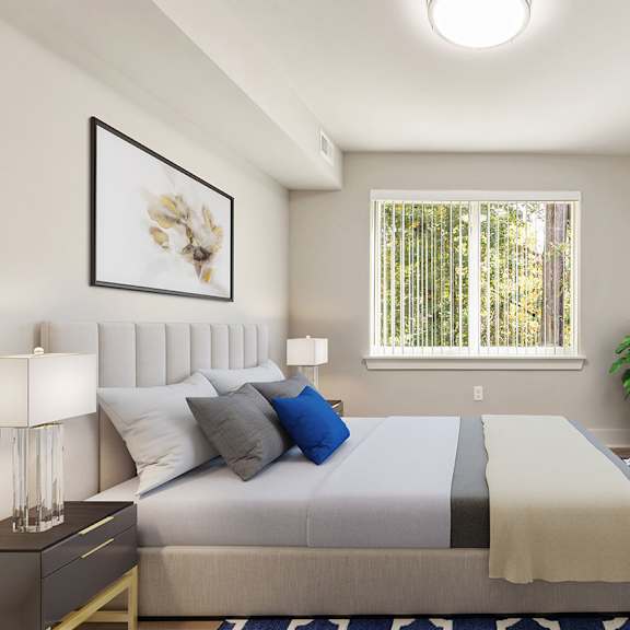 a bedroom with a bed, nightstand, and a plant.