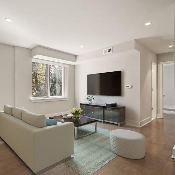 a modern living room with a large couch and a flat screen tv.