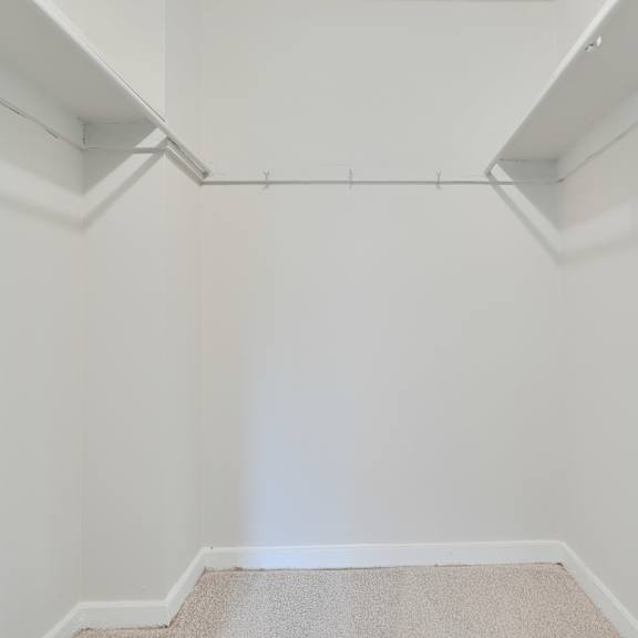a white room with a carpeted floor and white walls.