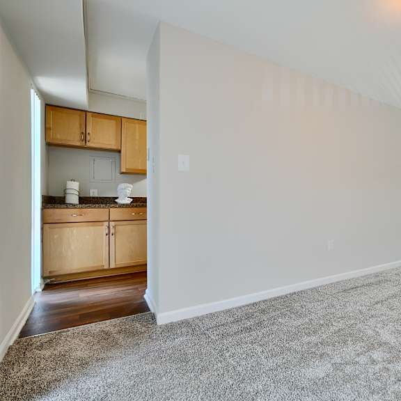 a large, empty room with a carpeted floor and white walls.