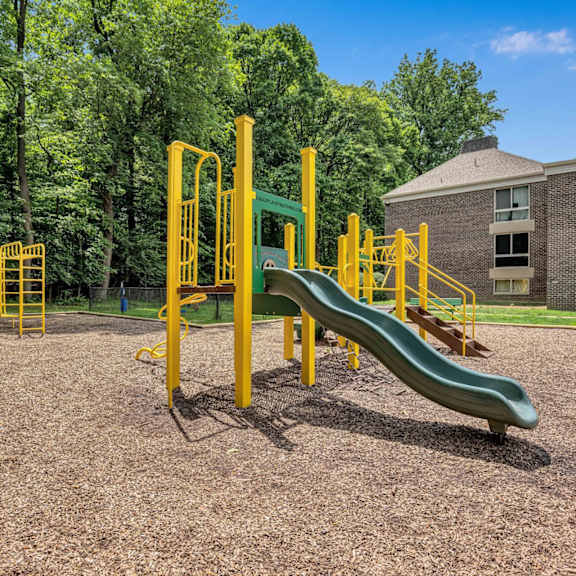 a playground with a slide and other playground equipment