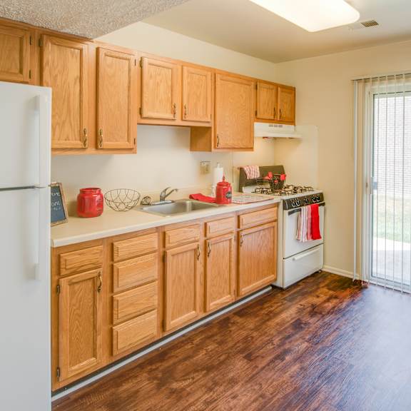 a kitchen with wooden cabinets and a white refrigerator.