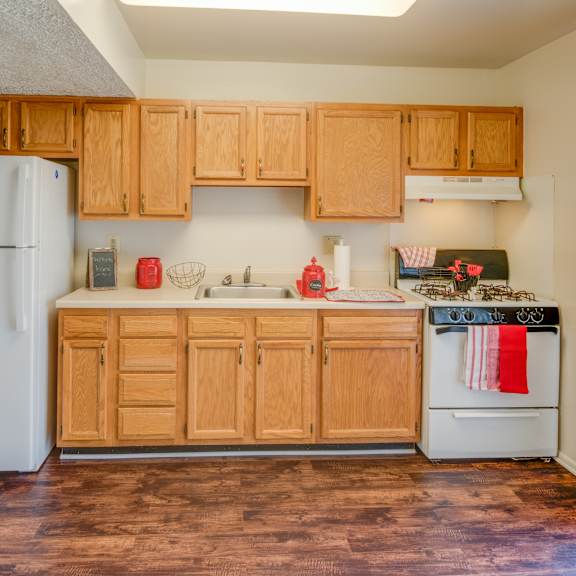 a kitchen with wooden cabinets and a white refrigerator.