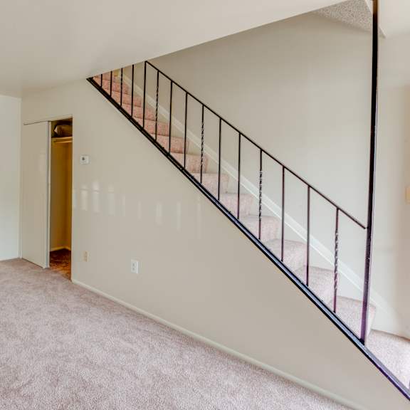 a room with a staircase and a door.
