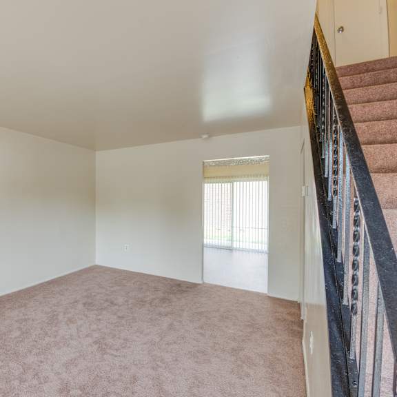 empty room with a staircase on the right side.
