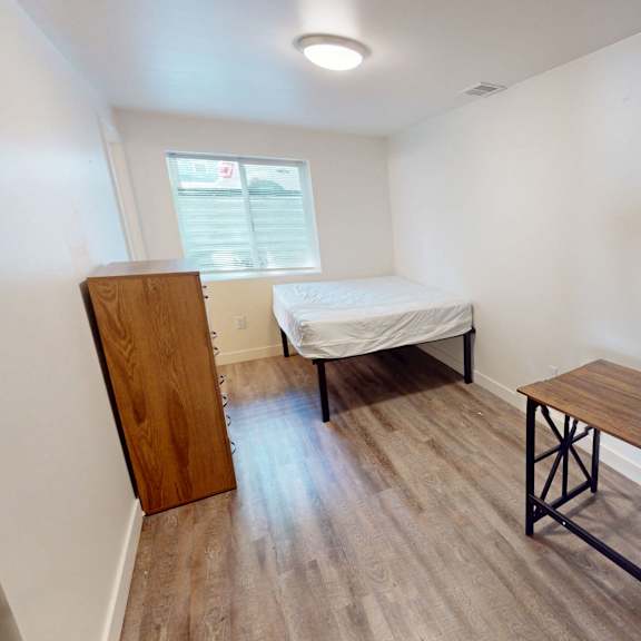 a room with a bed and a bench.
