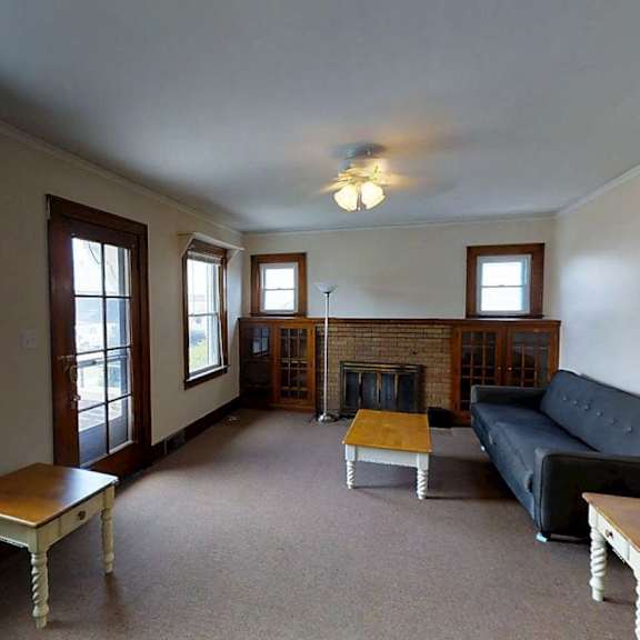 a living room with a fireplace and a couch.