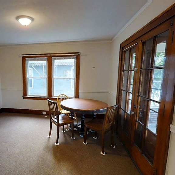 a room with a table and chairs in it.