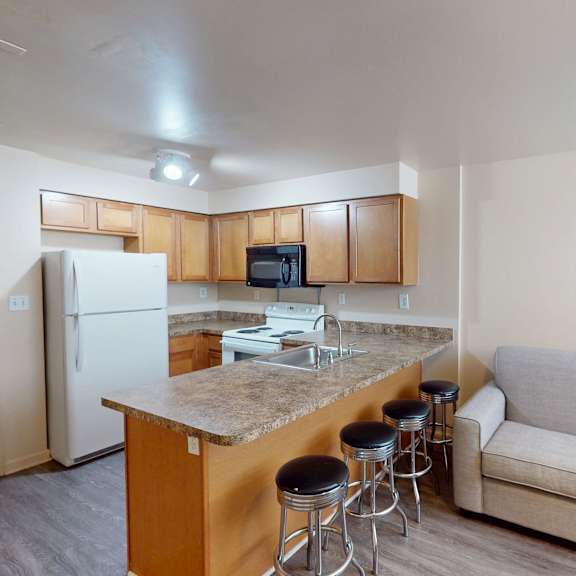 a kitchen with a bar and a couch.