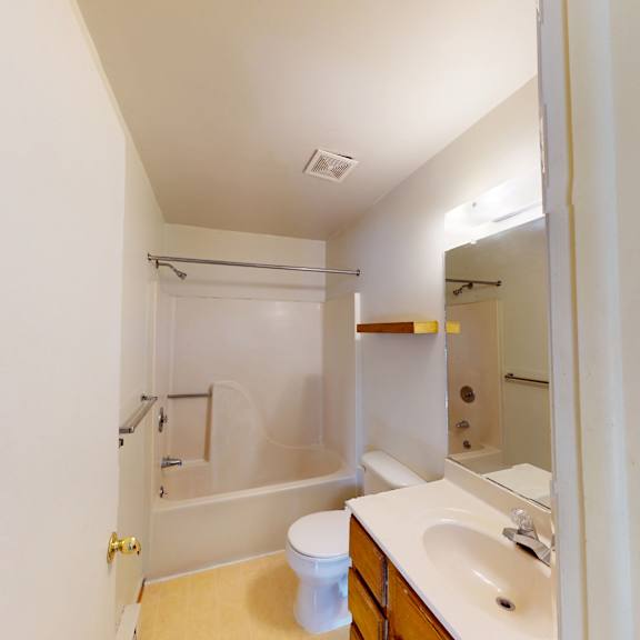 a white bathroom with a sink, toilet and bathtub.