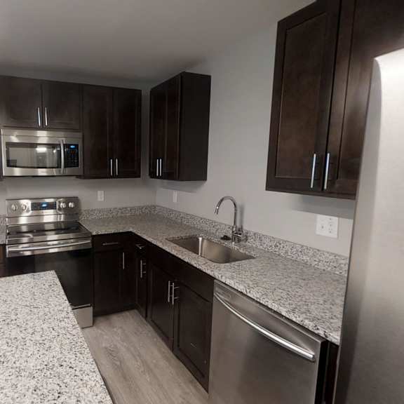 a kitchen with granite countertops and stainless steel appliances.