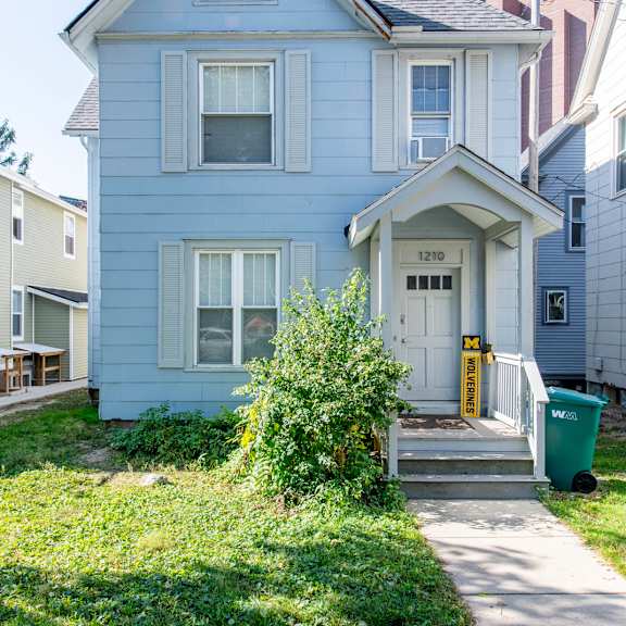 a blue house with a white door and windows.