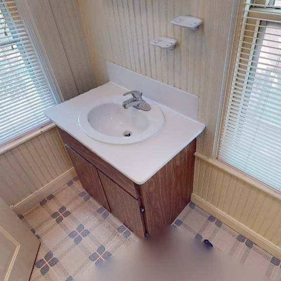 a bathroom with a sink and a window.