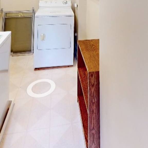 a white washing machine and dryer in a laundry room.