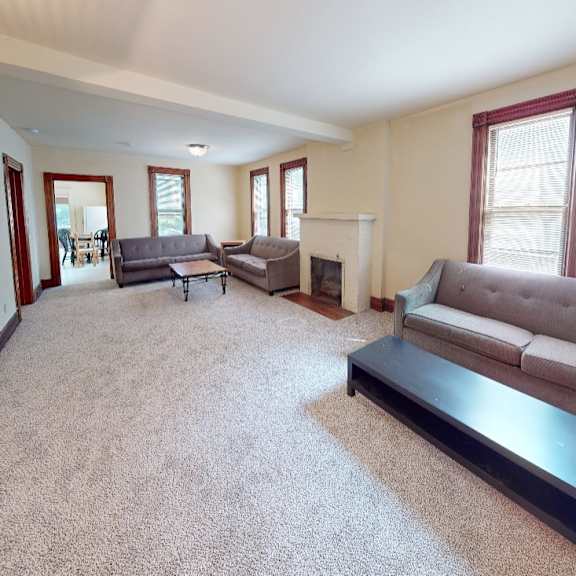 a living room with a grey couch and a black coffee table.