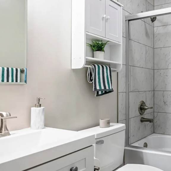 a white bathroom with a glass shower door.