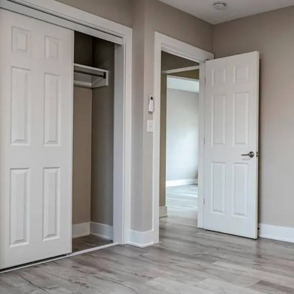 a room with two white doors and a wooden floor.