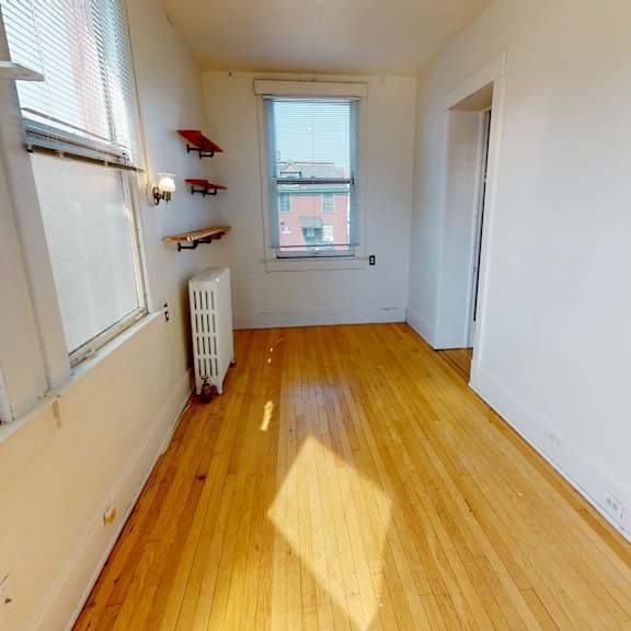 a room with a window and a radiator on the floor.