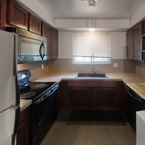 a kitchen with a white refrigerator and a white washing machine.