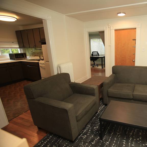 a living room with a grey couch and a black coffee table.