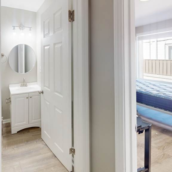 a white door with a mirror above it.