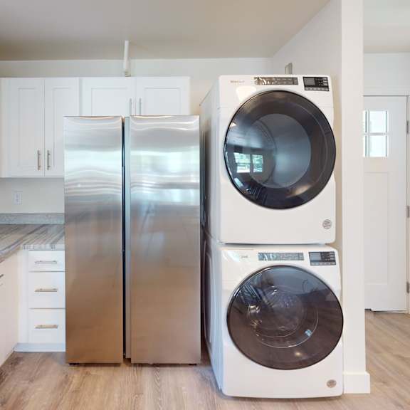 a modern kitchen with a stainless steel refrigerator and a white dishwasher.